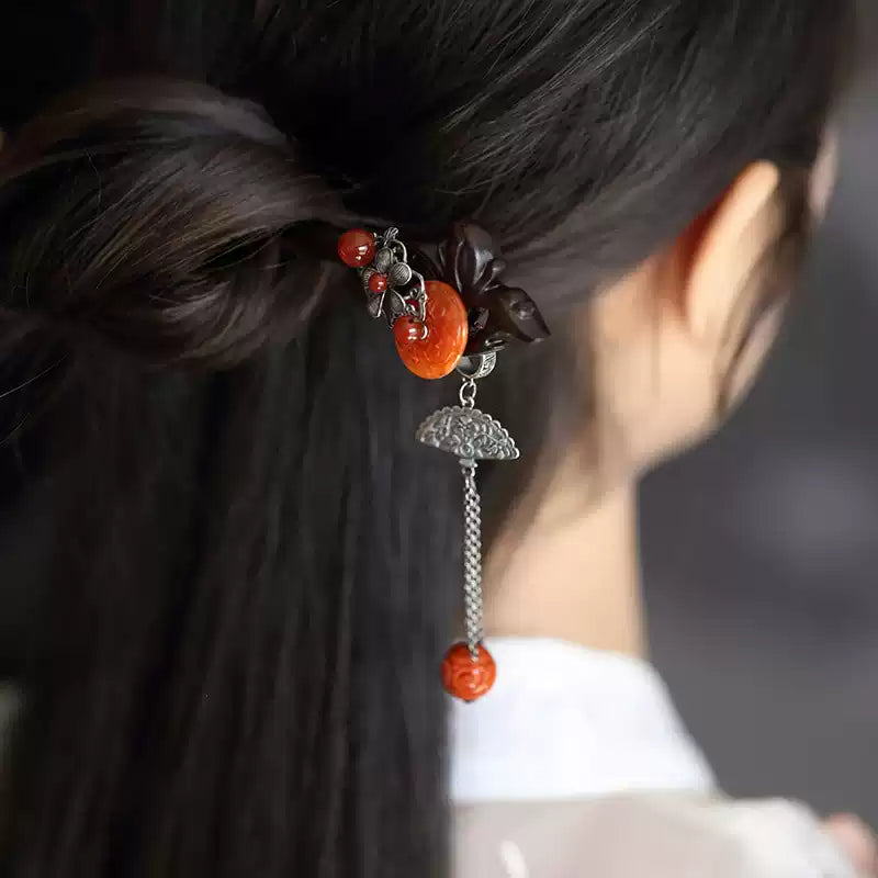 Detail view of the red ornament and tassel in the hair