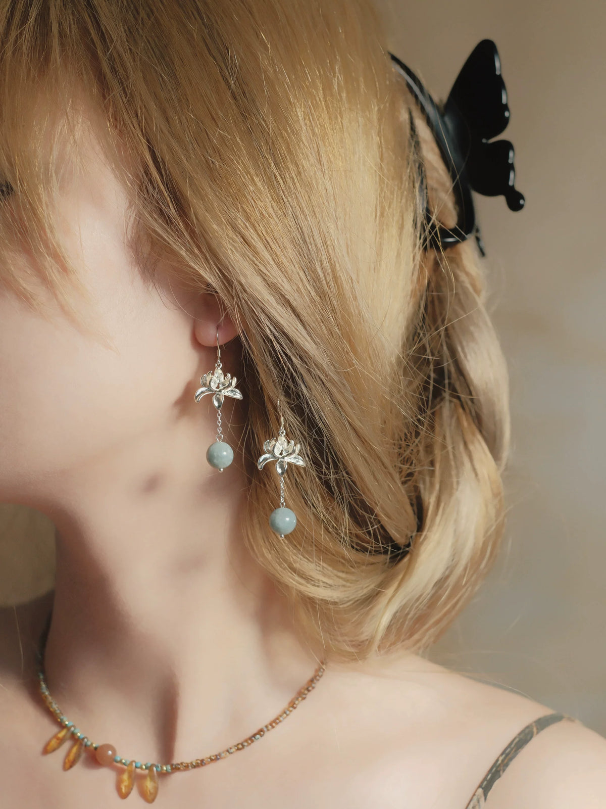 Silver-tone lotus petals, fine chain and round blue-green bead details