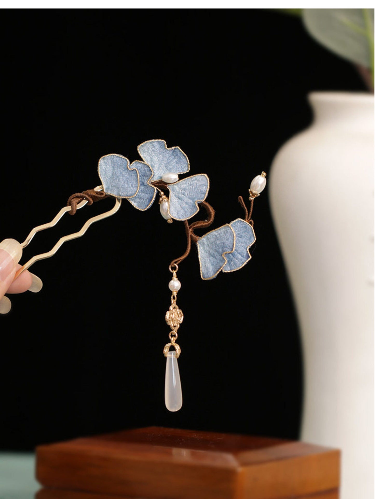 Close-up detail of yellow silk ginkgo leaf hairpin with faux pearl accent