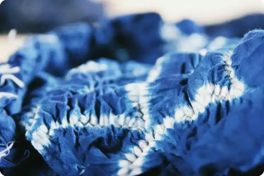Indigo-dyed fabric still bound with white resist areas