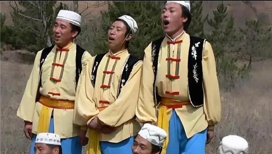 Dongxiang performers singing outdoors in traditional stage costumes