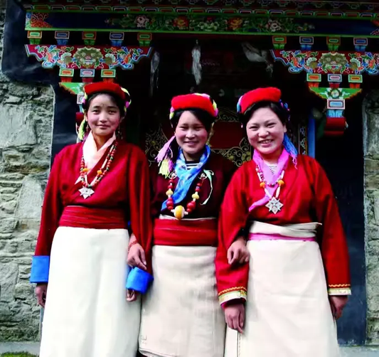 Monba women wearing red and white festival clothing