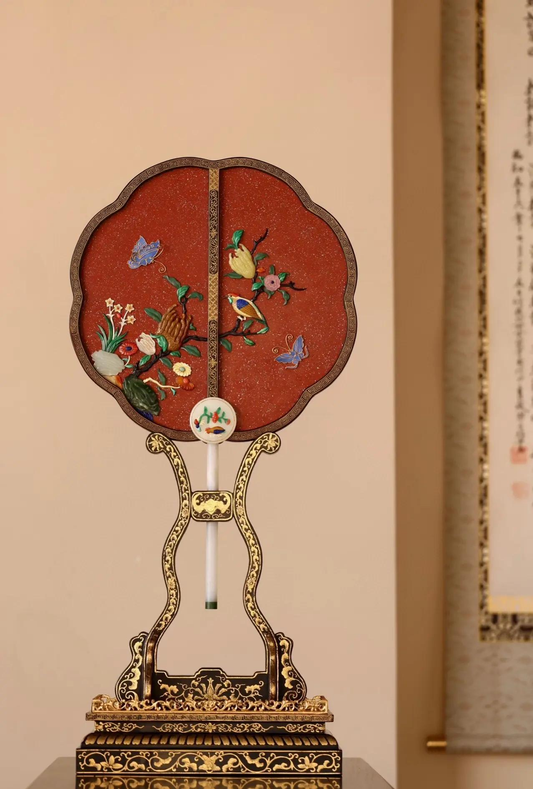 Court-style lobed fan with hardstone flower and bird decoration on a display stand