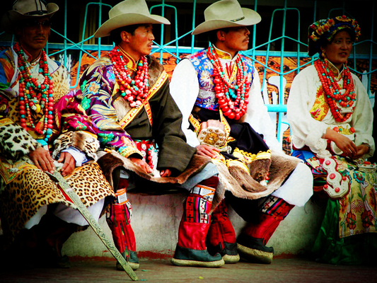 People in colorful clothing and jewelry at a community gathering