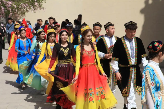 People taking part in a community dance or celebration in colorful clothing