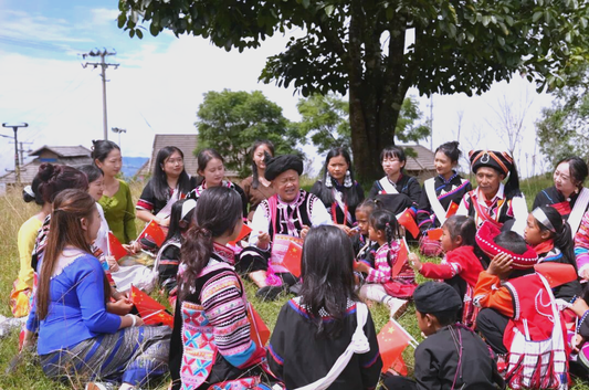 Wa community members gathering outdoors in traditional and modern clothing