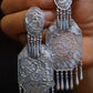 Close-up of the matching pair of peony motif tassel earrings