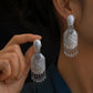 Pair of ornate peony tassel drop earrings shown worn and held in hand