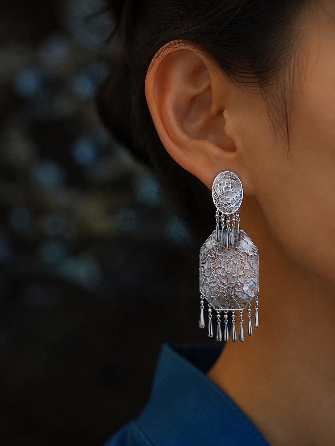 Close-up view of a peony drop earring and its dangling tassel details