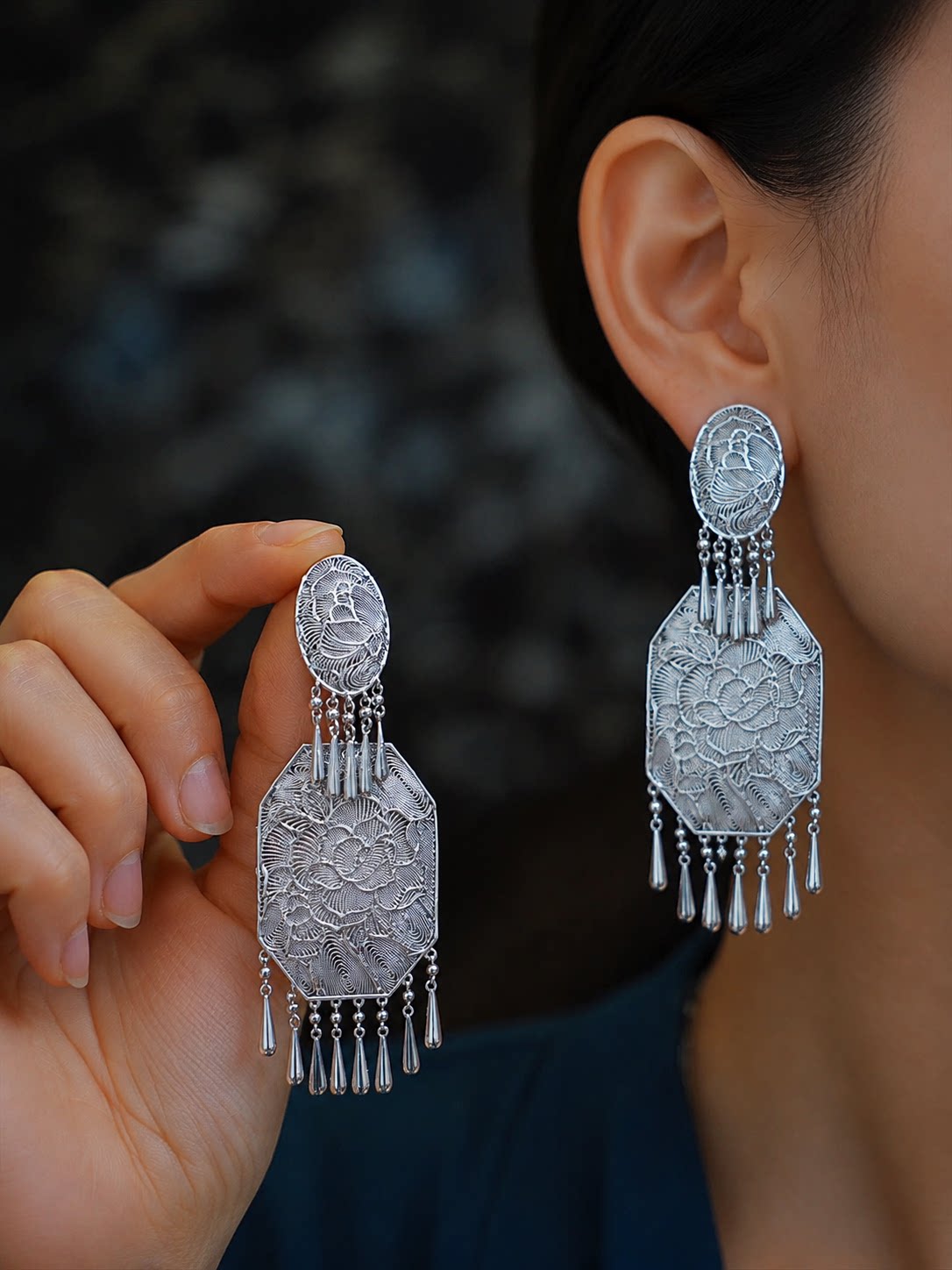 Pair of silver-tone copper peony tassel earrings shown worn and held for scale