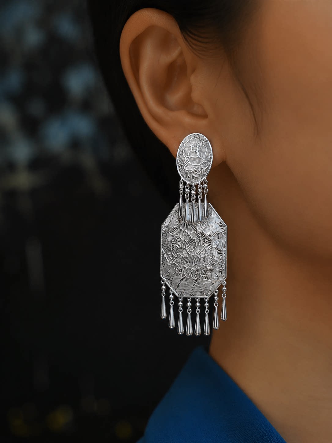 Silver-tone copper peony motif drop earring with dangling tassels shown worn