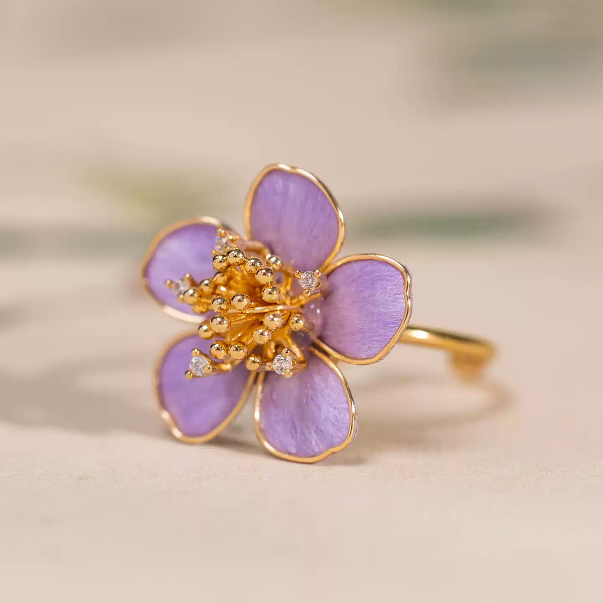 Side detail of the purple floral ring showing its raised flower design
