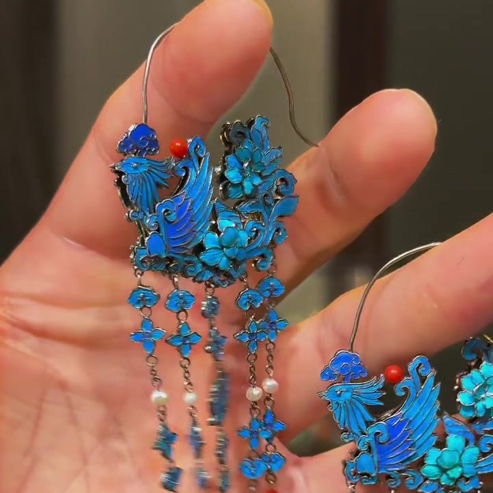 Pair of phoenix tassel earrings showing pale bead accents and blue floral details