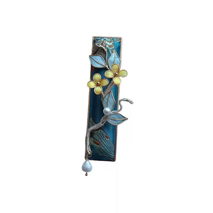 Deep blue floral hair clip with a beaded drop on a white background
