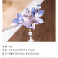 Close-up detail of the purple flower ornament and decorative beadwork