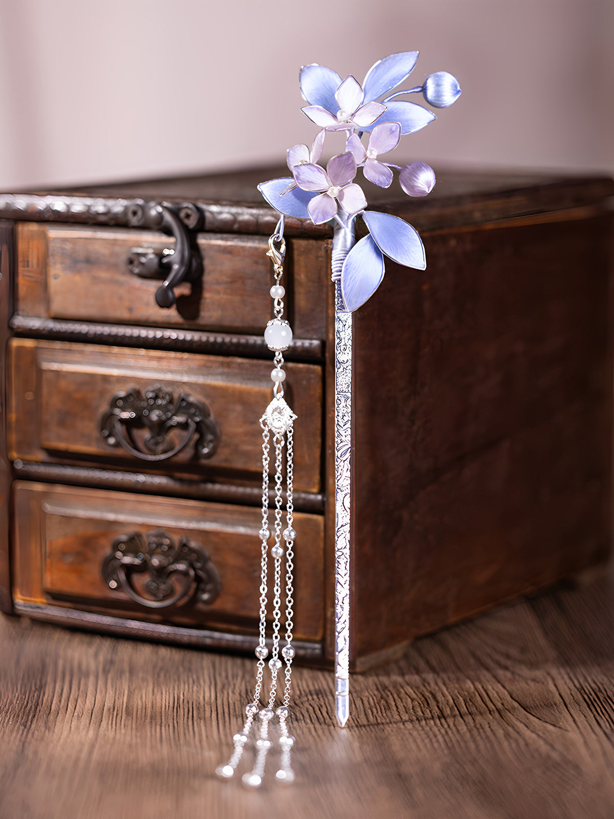 Full view of a purple floral hairpin and long tassel