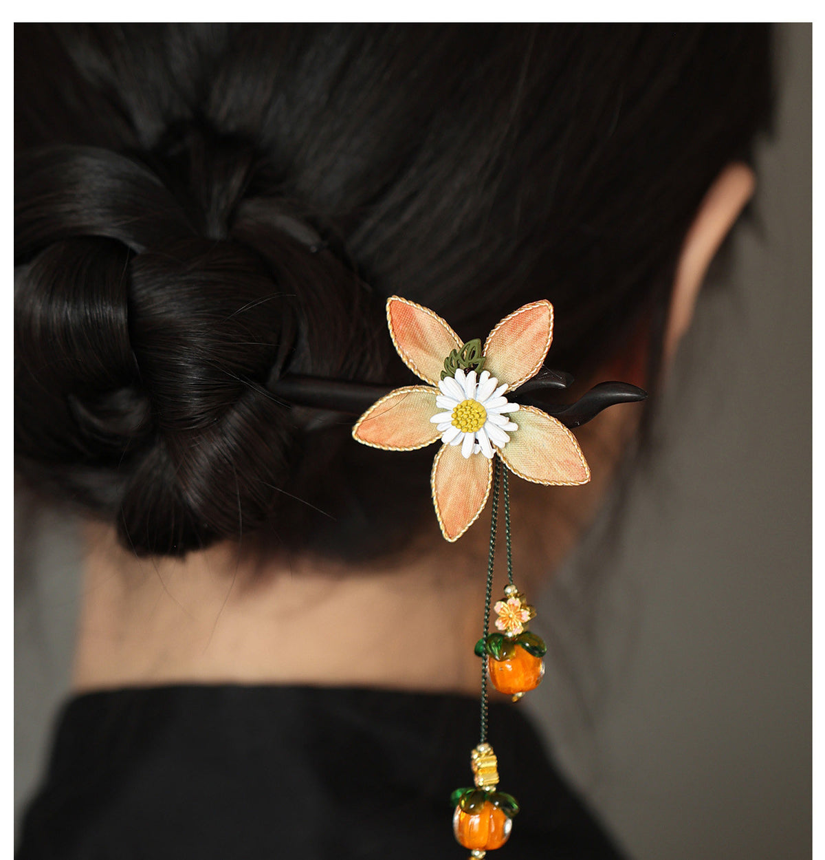 Chrysanthemum and persimmon hair stick worn in a bun
