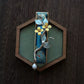 Deep blue osmanthus hair clip displayed vertically with its bead drop