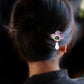 Purple peony sandalwood hairpin styled in dark hair