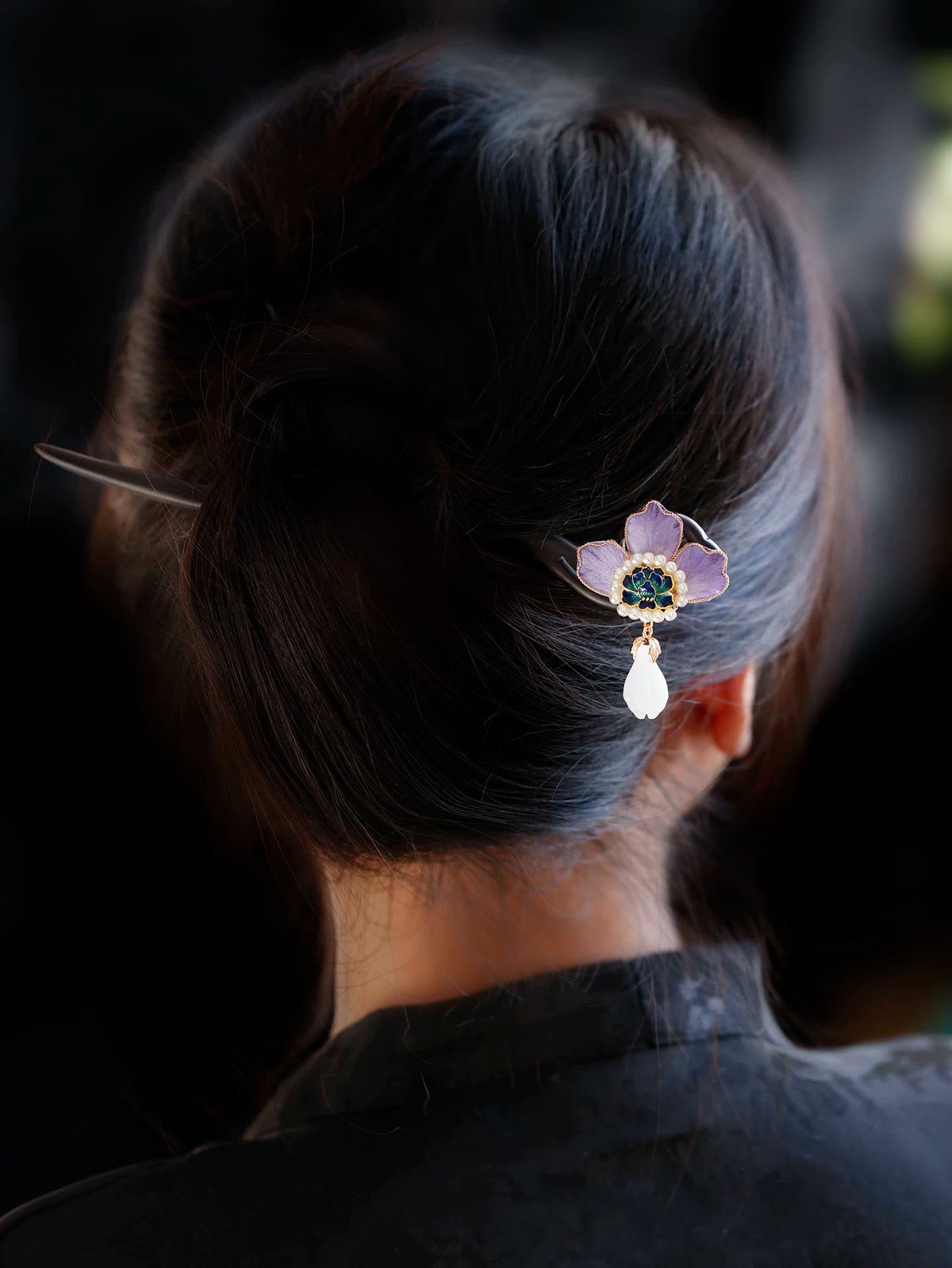 Purple peony sandalwood hairpin styled in dark hair