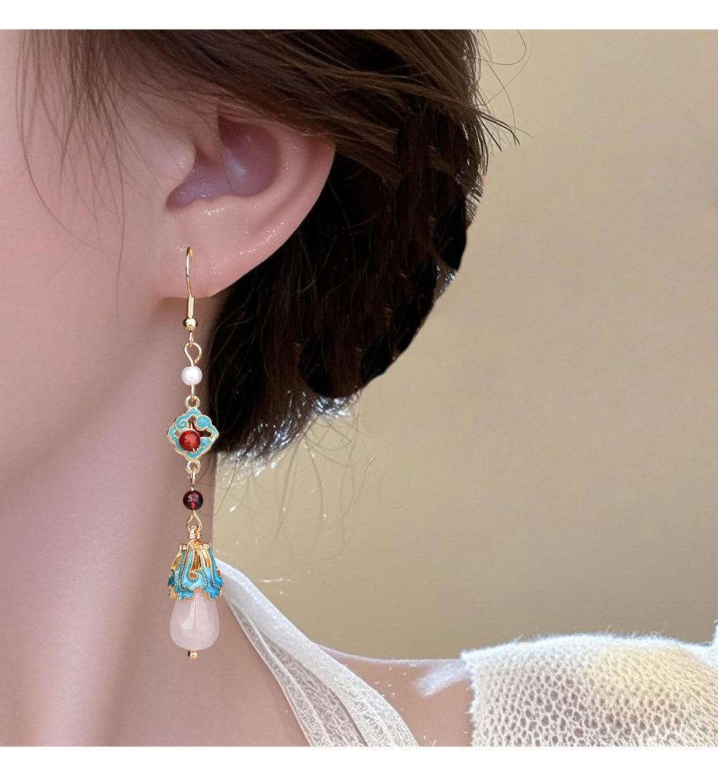 Long red and turquoise earring worn, detail view