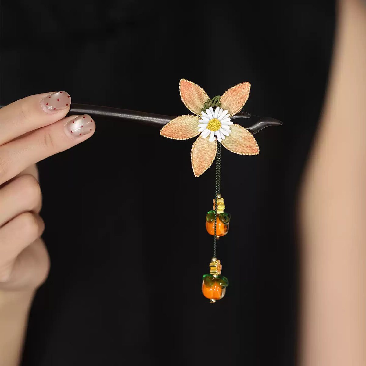 Full view of the ebony wood hair stick and floral persimmon decorations