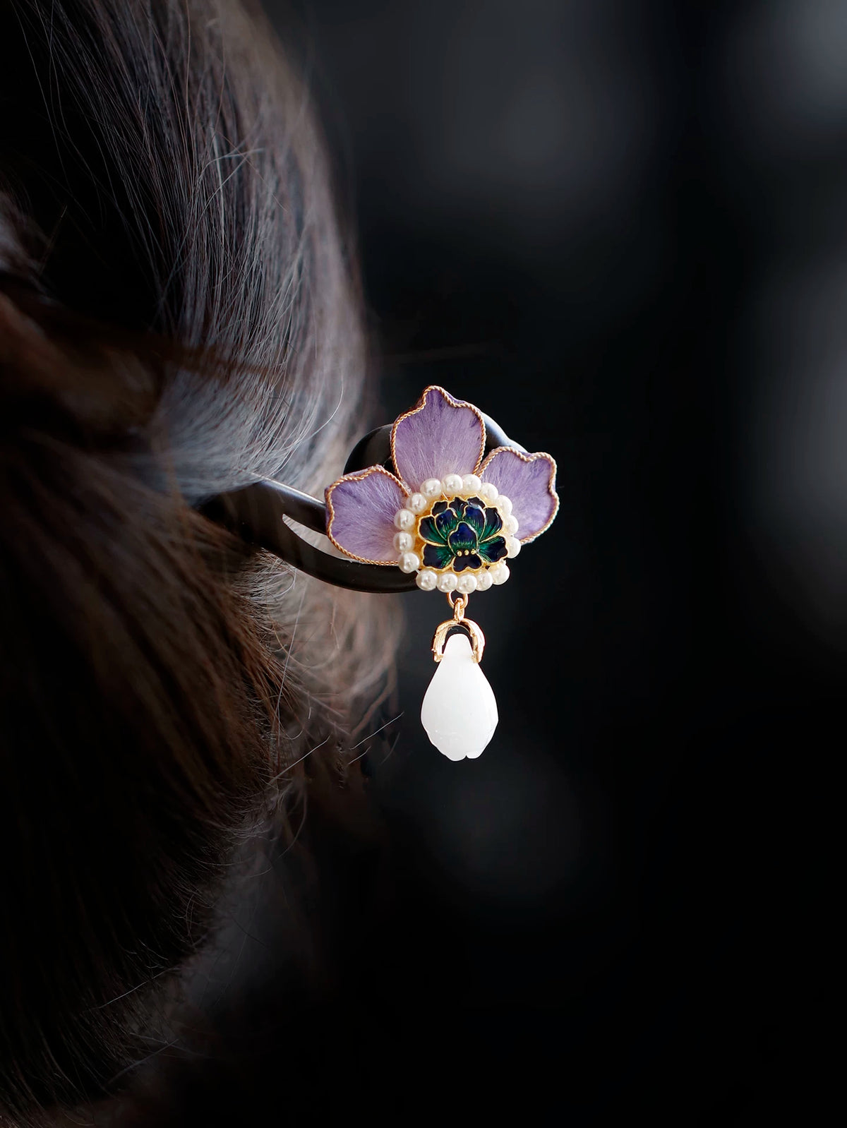 Close view of the purple peony flower and pearl-like accents