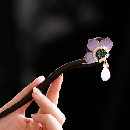 Purple peony wooden hairpin held in hand, full view
