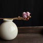 Pink fabric gourd hairpin displayed on a vase against a dark backdrop; vase is not included