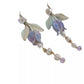 Pair of lily of the valley earrings on a clean light background