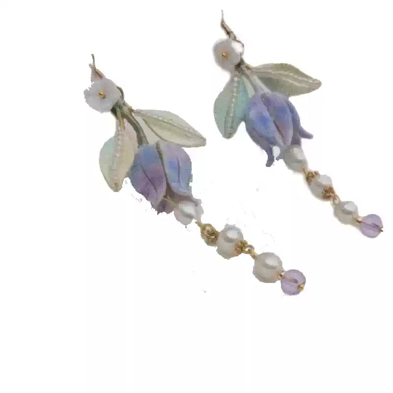 Pair of lily of the valley earrings on a clean light background