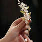 White flowers green leaves orchids tassels hairpins