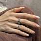 Close view of adjustable ring with Chinese inscription and red bead accent