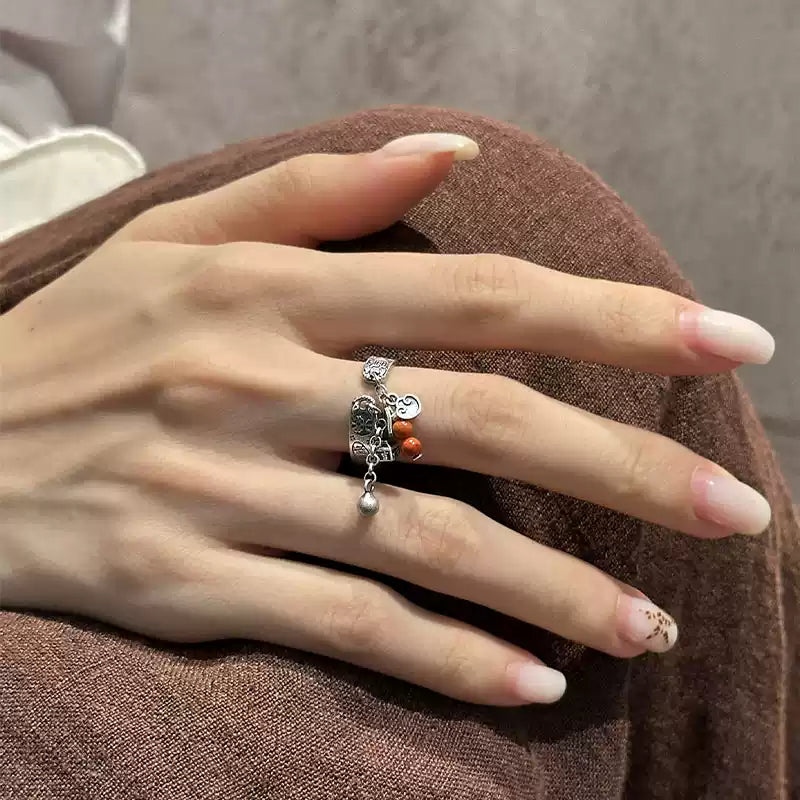 Close view of adjustable ring with Chinese inscription and red bead accent