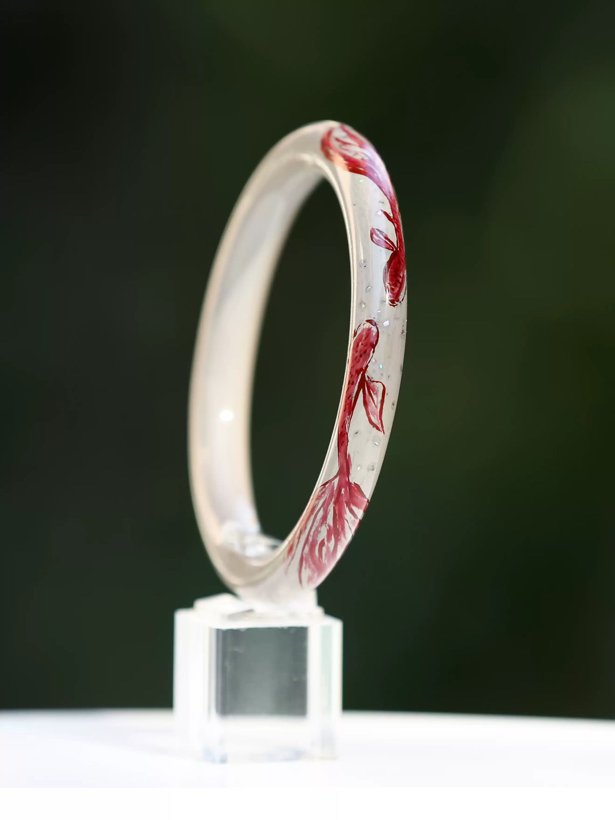 Koi motif bangle displayed upright, showing the inner band and lacquer finish