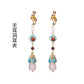 Red and turquoise long drop earrings with clip-on fittings, pair on a clean white background