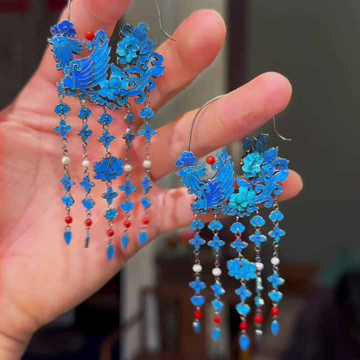 Close-up of the phoenix and floral design on the blue tassel drop earrings