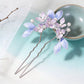 Single U-shaped purple floral hair fork with dangling tassel