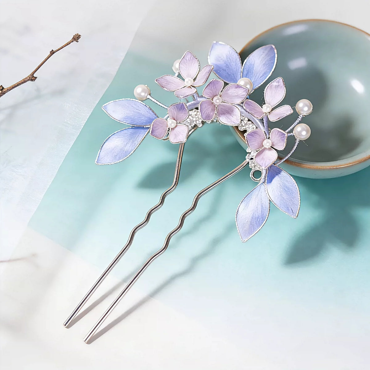 Single U-shaped purple floral hair fork with dangling tassel