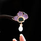 Detailed view of the purple peony hairpin held in hand