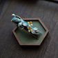 Angled view of the deep blue osmanthus hair clip