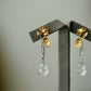 Long floral gourd drop earrings shown together on a neutral display stand.