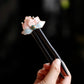 Handmade flower wooden hairpin on black background