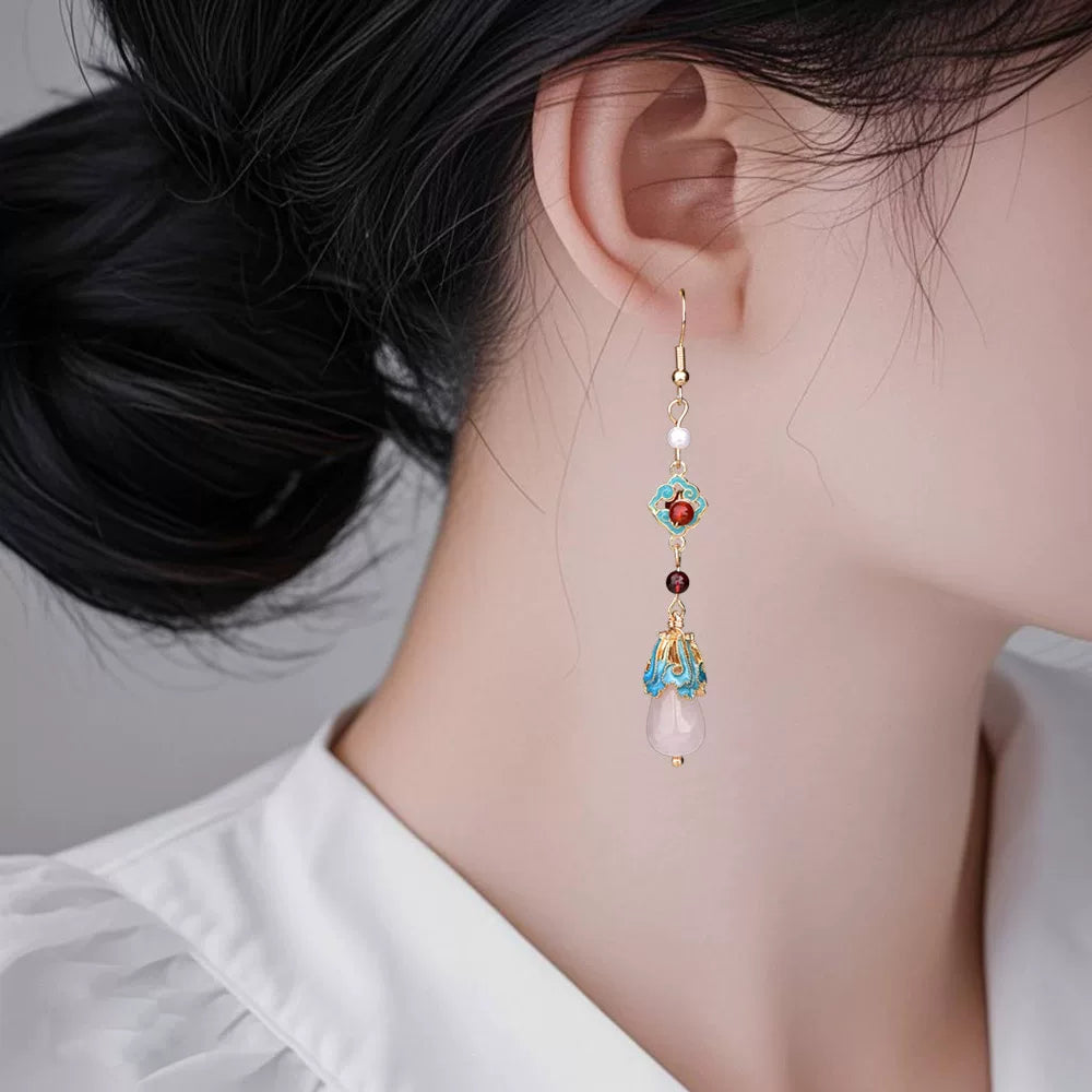 Long red and turquoise earrings worn, side profile