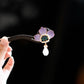 Purple peony hair stick shown from the side