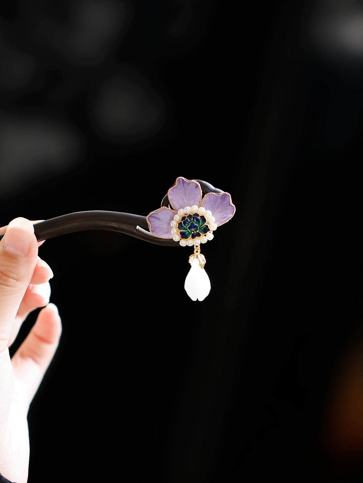 Purple peony hair stick shown from the side