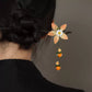 Silk chrysanthemum hair stick with glass persimmon drops in a bun