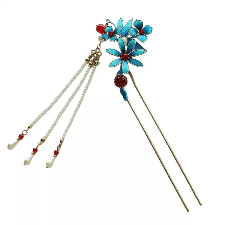 Pair of blue floral hair sticks with white dangling bead strands and red accents