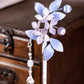 Close-up of the floral hairpin components and tassel details