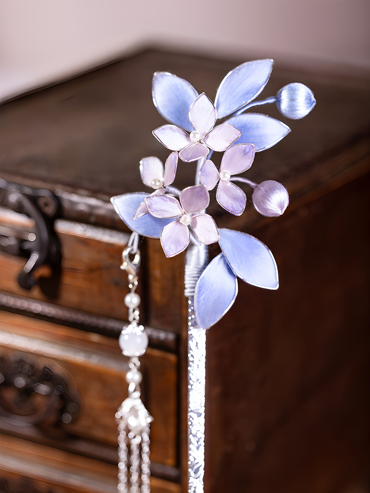 Close-up of the floral hairpin components and tassel details